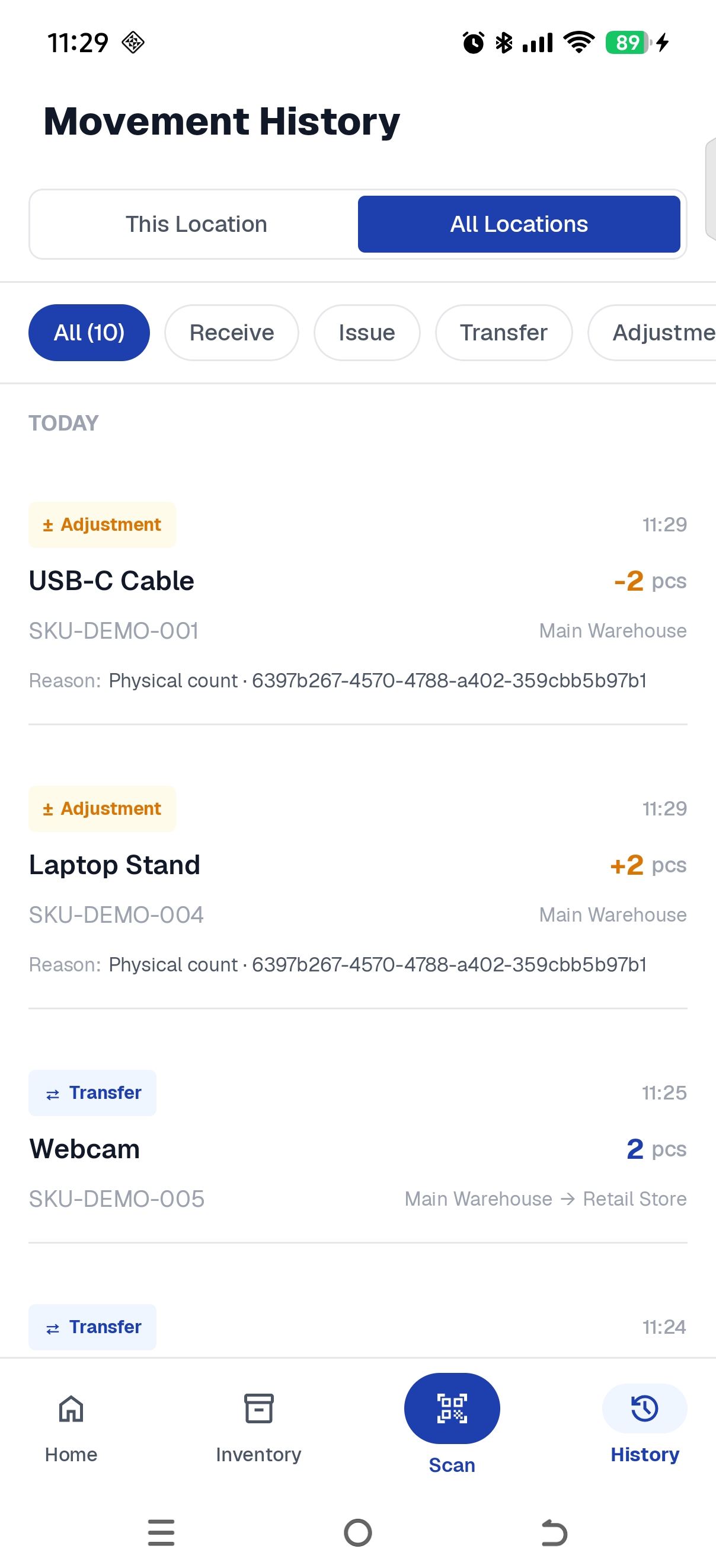 Movement History screen, All Locations tab, listing two Adjustment entries at the top: USB-C Cable minus 2 pcs and Laptop Stand plus 2 pcs, both at Main Warehouse with the reason Physical count and a session identifier, followed by Transfer entries between Main Warehouse and Retail Store.
